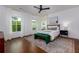 Bright bedroom features large windows, hardwood floors, and a cozy rug at 302 Boxwood Ln, Roswell, GA 30075