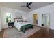 Bright bedroom with a large window, ceiling fan, and en-suite bathroom at 302 Boxwood Ln, Roswell, GA 30075