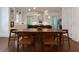 Open dining room with modern chandelier, wood floors, and view of the modern kitchen and its features at 302 Boxwood Ln, Roswell, GA 30075