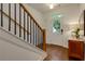 Welcoming foyer showcasing hardwood floors, a staircase with dark rails, and a door to the outside at 302 Boxwood Ln, Roswell, GA 30075