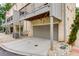 A well-lit, attached garage features a gray door and ample parking space, complemented by stone landscaping at 302 Boxwood Ln, Roswell, GA 30075