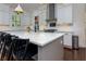 Contemporary kitchen with white cabinets, stylish pendant lights, and a large center island with breakfast bar at 302 Boxwood Ln, Roswell, GA 30075