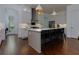 Spacious kitchen with white cabinets, stainless steel appliances, and a large center island with barstool seating at 302 Boxwood Ln, Roswell, GA 30075