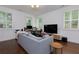 Comfortable living room with a large sofa and desk, perfect for relaxing or working at 302 Boxwood Ln, Roswell, GA 30075