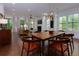 Spacious open-concept living room with wooden dining table and hardwood floors throughout at 302 Boxwood Ln, Roswell, GA 30075