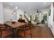 Bright and airy living space adjacent to dining area, featuring a staircase and many windows at 302 Boxwood Ln, Roswell, GA 30075