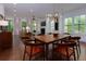 Spacious living and dining area featuring hardwood floors, modern light fixture, and fireplace at 302 Boxwood Ln, Roswell, GA 30075