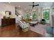 Cozy living room with plush seating, fireplace, hardwood floors, and bright natural light at 302 Boxwood Ln, Roswell, GA 30075