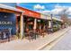 A lively restaurant patio features outdoor seating with tables, umbrellas, and charming street views at 302 Boxwood Ln, Roswell, GA 30075