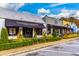 A street view of Vinings Gallery features quaint shops with awnings and manicured landscaping at 302 Boxwood Ln, Roswell, GA 30075