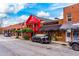 A vibrant street showcases Vinings Gallery with colorful buildings, black cars, and unique local shops at 302 Boxwood Ln, Roswell, GA 30075