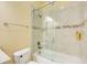 Tiled bathroom features a shower and tub combo, sliding glass door, and modern fixtures at 332 Warwick Pl, Mcdonough, GA 30253