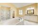 The bathroom is well-appointed with granite countertops, dual sinks, glass enclosed shower, and a large soaking tub at 332 Warwick Pl, Mcdonough, GA 30253