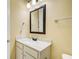 Bathroom with white vanity, framed mirror, modern faucet, and neutral wall color at 332 Warwick Pl, Mcdonough, GA 30253