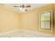 Bedroom features marble floors, neutral walls, ceiling fan, and natural light from the window at 332 Warwick Pl, Mcdonough, GA 30253
