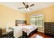 Cozy bedroom with hardwood floors, a ceiling fan and a window that allows natural light at 332 Warwick Pl, Mcdonough, GA 30253