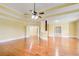 Expansive bedroom features beautiful hardwood floors, tray ceilings, and seamless access to the ensuite bathroom and closets at 332 Warwick Pl, Mcdonough, GA 30253