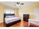 Comfortable bedroom with hardwood floors, a large window, and a sleek ceiling fan at 332 Warwick Pl, Mcdonough, GA 30253