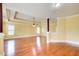 Bright bedroom features a tray ceiling, hardwood floors, a ceiling fan, and natural light from multiple windows at 332 Warwick Pl, Mcdonough, GA 30253