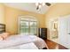 A bedroom features a neutral palette, a large window, and an ensuite bathroom at 332 Warwick Pl, Mcdonough, GA 30253