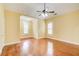 The well-lit bedroom features hardwood flooring, large windows, and neutral paint at 332 Warwick Pl, Mcdonough, GA 30253