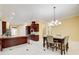 Bright dining area featuring a table for six and views into the updated kitchen at 332 Warwick Pl, Mcdonough, GA 30253