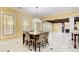 Dining area featuring a decorative chandelier, plantation shutters, and an open layout at 332 Warwick Pl, Mcdonough, GA 30253