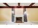 Living area with a fireplace featuring stone accents and custom coffered ceiling at 332 Warwick Pl, Mcdonough, GA 30253