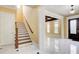 Foyer features a staircase, front door, and view of the living room with marble floors at 332 Warwick Pl, Mcdonough, GA 30253
