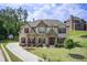 Stunning front exterior with stone accents, shutters, and a well-manicured lawn at 332 Warwick Pl, Mcdonough, GA 30253