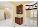 Hallway with a built-in dry bar that features wooden cabinets, stone countertops, and glass storage at 332 Warwick Pl, Mcdonough, GA 30253