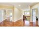 Hallway with hardwood floors, views of the living room, bedrooms, and a staircase at 332 Warwick Pl, Mcdonough, GA 30253