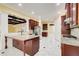 Open kitchen showcasing a large island, marble tile floors, custom cabinets, and stainless steel appliances at 332 Warwick Pl, Mcdonough, GA 30253