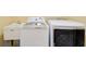 Well-equipped laundry room features a utility sink, washing machine, and dryer at 332 Warwick Pl, Mcdonough, GA 30253