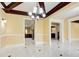 Spacious living area featuring a decorative chandelier, elegant marble flooring, and views into the kitchen at 332 Warwick Pl, Mcdonough, GA 30253