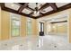 Spacious living room featuring marble floors, coffered ceiling, arched windows, and natural light at 332 Warwick Pl, Mcdonough, GA 30253