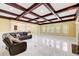 Bright living room boasts marble floors, coffered ceiling, fireplace, and flows into the kitchen area at 332 Warwick Pl, Mcdonough, GA 30253