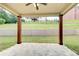 Covered patio with stone floors, timber supports, and a view of the green backyard at 332 Warwick Pl, Mcdonough, GA 30253