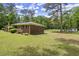Brick home with a green lawn, featuring a view of the spacious side yard at 3630 Spot Rd, Cumming, GA 30040