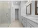 Bathroom featuring a glass shower, white cabinetry, dual sinks, and marble flooring at 5448 Howington E Ct # 194, Buford, GA 30518