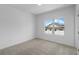 A bright bedroom with neutral carpet and walls, featuring a window that offers natural light at 5448 Howington E Ct # 194, Buford, GA 30518