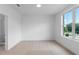 Spacious bedroom with large window, neutral carpet, and an ensuite bathroom at 5448 Howington E Ct # 194, Buford, GA 30518
