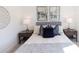 Cozy bedroom with decorative pillows, bedside tables, and modern lamps at 5448 Howington E Ct # 194, Buford, GA 30518
