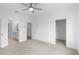 Bedroom with adjoining bathroom, spacious closet, neutral walls, carpeted floor, and modern fan at 5448 Howington E Ct # 194, Buford, GA 30518