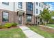 Beautiful brick townhome with manicured lawn, featuring modern architectural details and a welcoming entrance at 5448 Howington E Ct # 194, Buford, GA 30518