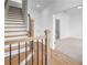 Bright foyer with hardwood floors and staircase, leading to a spacious open-concept living area at 5448 Howington E Ct # 194, Buford, GA 30518