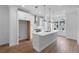 Modern, open kitchen design with white cabinets, stainless steel appliances, and a large center island at 5448 Howington E Ct # 194, Buford, GA 30518