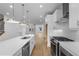 Bright open kitchen featuring stainless steel appliances, modern cabinetry, and a large center island at 5448 Howington E Ct # 194, Buford, GA 30518