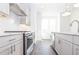 This modern kitchen offers bright white cabinets, stainless appliances, and light countertops at 5448 Howington E Ct # 194, Buford, GA 30518