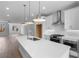 Bright kitchen boasts a large island with quartz countertops and stainless steel appliances at 5448 Howington E Ct # 194, Buford, GA 30518